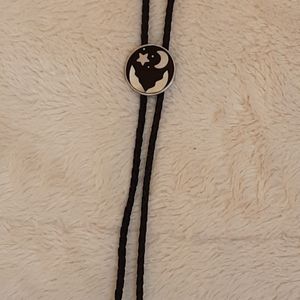 VINTAGE BOLO TIE WITH SHELL INLAY OF MOON AND STARS.